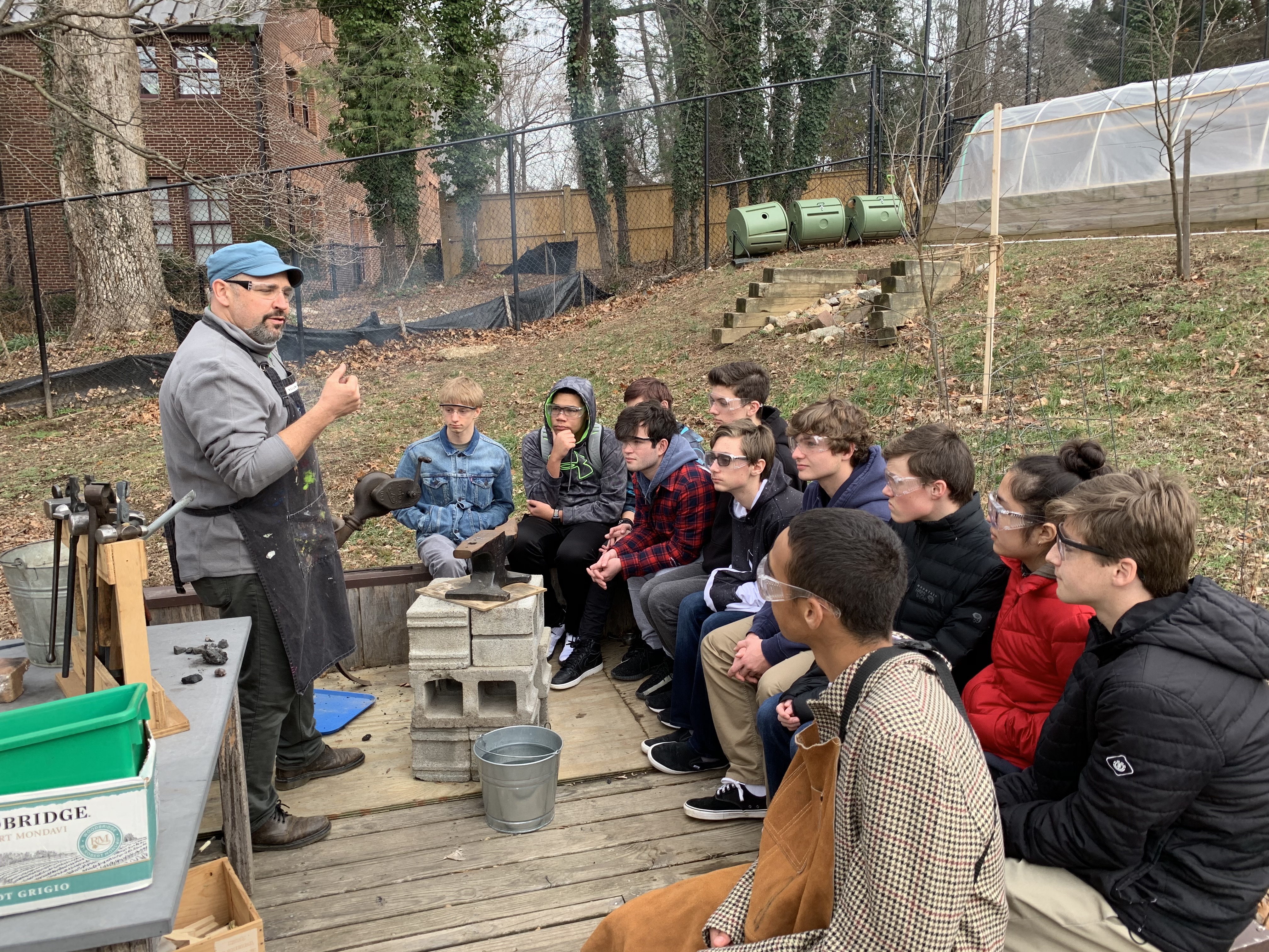 teacher talking to students outside about using metalsmithing tools