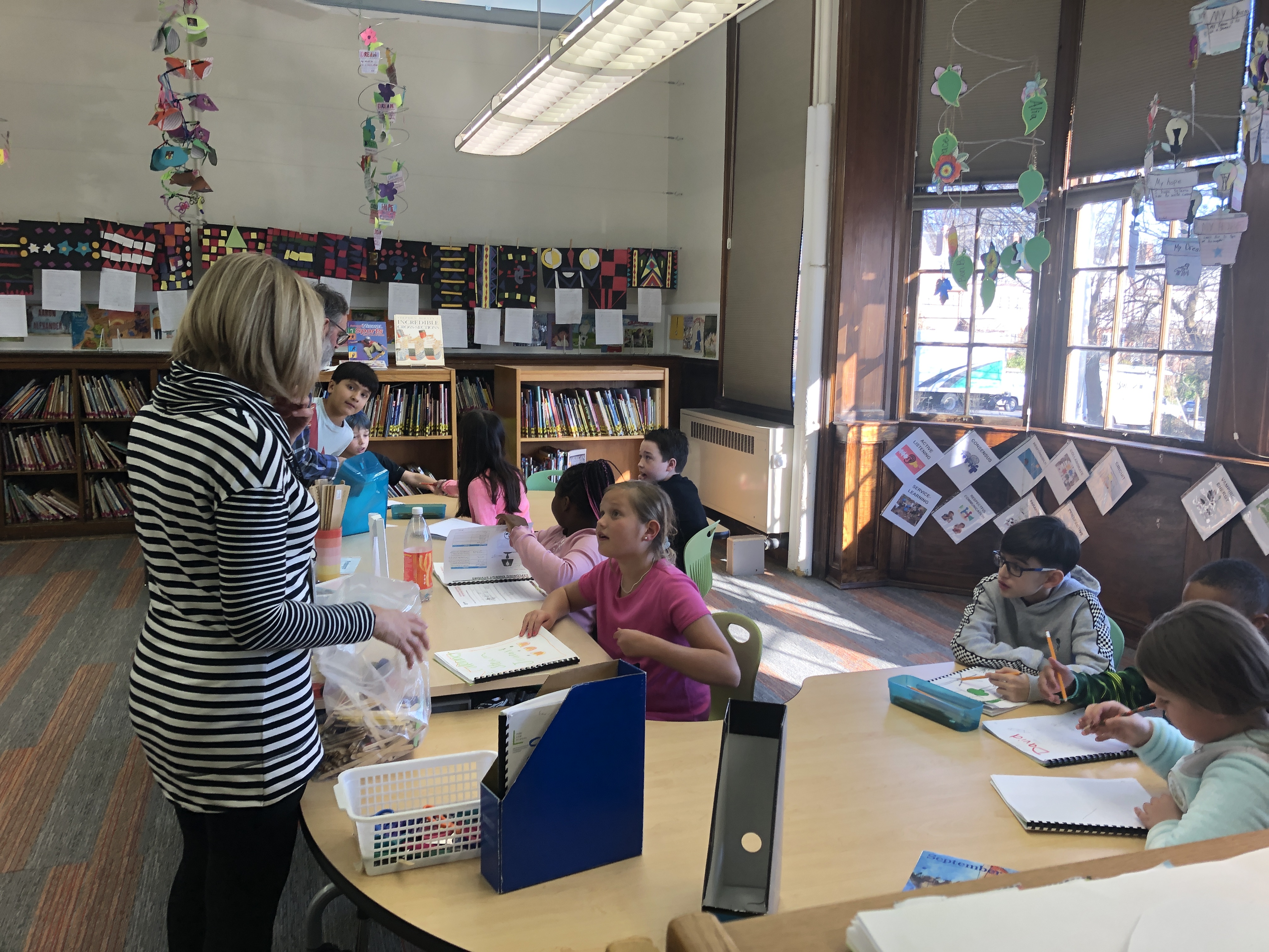 students write in notebooks in classroom