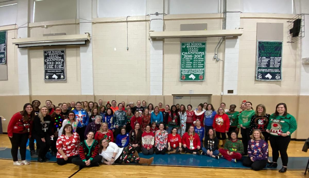 Group photo of staff wearing ugly Christmas sweaters