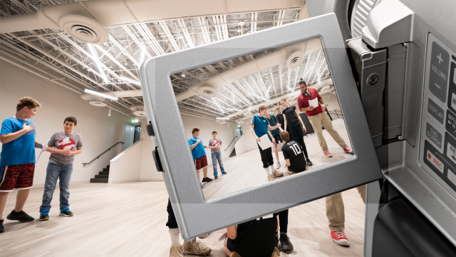 Video camera shooting students in movement studio